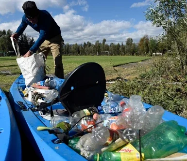 Plastic bottles and other waste being removed from the waters of Xochimilco, highlighting the pollution threatening the wild axolotl and the conservation message behind Atlalli.